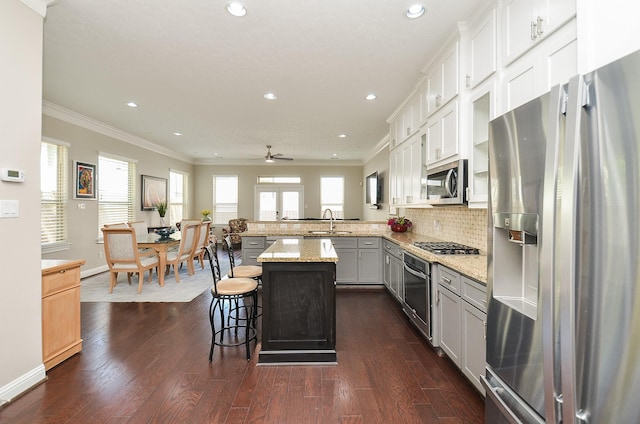 1913 Rosewood St, Houston, TX 77004 - kitchen with stainless steel appliances, a sink, recessed lighting, ornamental molding, and dark wood-style flooring