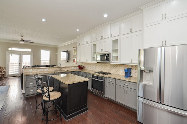 1913 Rosewood St, Houston, TX 77004 - kitchen with appliances with stainless steel finishes, a sink, gray cabinetry, a peninsula, and crown molding