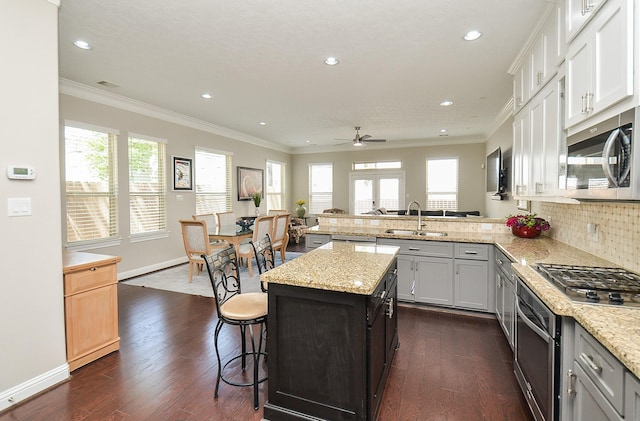 1913 Rosewood St, Houston, TX 77004 - kitchen with stainless steel appliances, a sink, healthy amount of natural light, dark wood-type flooring, and recessed lighting