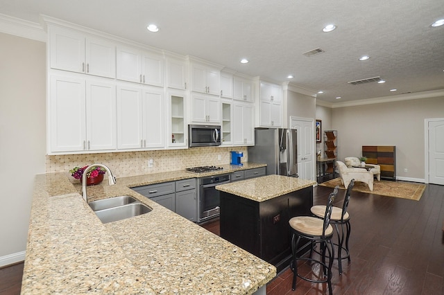 1913 Rosewood St, Houston, TX 77004 - kitchen with appliances with stainless steel finishes, a sink, ornamental molding, decorative backsplash, and baseboards