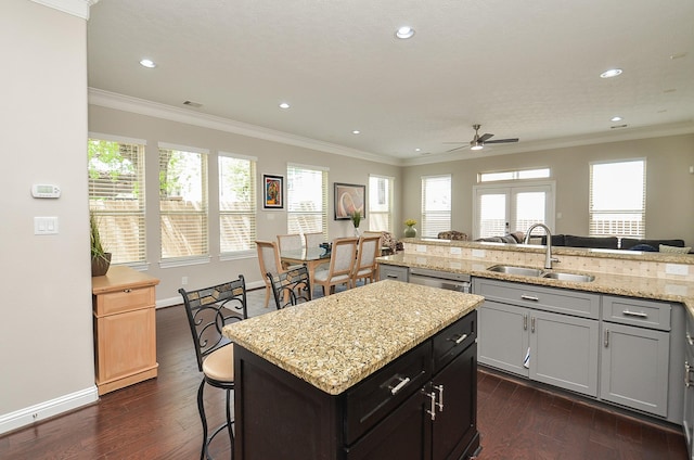 1913 Rosewood St, Houston, TX 77004 - kitchen featuring a sink, a ceiling fan, dark wood-style flooring, recessed lighting, and a kitchen breakfast bar