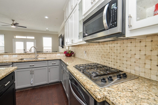1913 Rosewood St, Houston, TX 77004 - kitchen with appliances with stainless steel finishes, a sink, ornamental molding, ceiling fan, and light stone counters