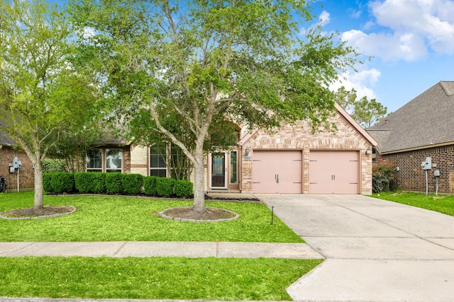 2314 Laurel Loch Ln, Pearland, TX 77584 - view of property hidden behind natural elements with brick siding, a garage, a front lawn, and driveway