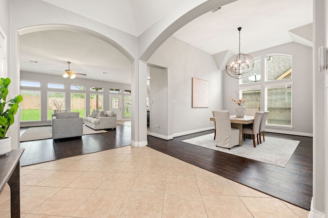 2314 Laurel Loch Ln, Pearland, TX 77584 - dining room with a ceiling fan, vaulted ceiling, arched walkways, tile patterned flooring, and baseboards