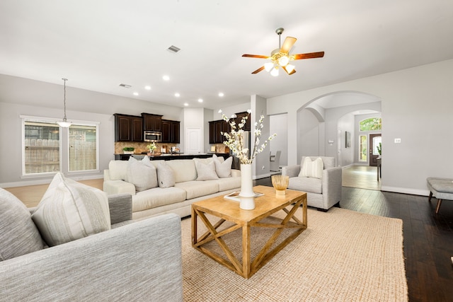 2314 Laurel Loch Ln, Pearland, TX 77584 - living room featuring arched walkways, ceiling fan, wood-type flooring, baseboards, and recessed lighting