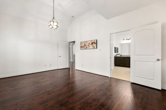 2314 Laurel Loch Ln, Pearland, TX 77584 - empty room with dark wood-style flooring, high vaulted ceiling, and baseboards