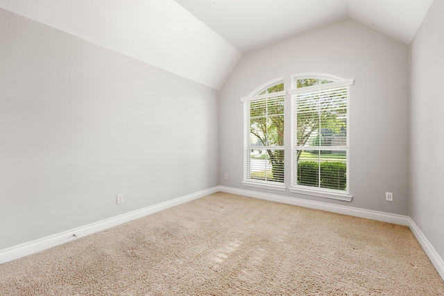 2314 Laurel Loch Ln, Pearland, TX 77584 - empty room with light carpet, vaulted ceiling, and baseboards
