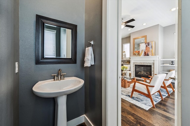 783 Waverly St, Houston, TX 77007 - bathroom featuring wood finished floors, a glass covered fireplace, a textured wall, a ceiling fan, and recessed lighting