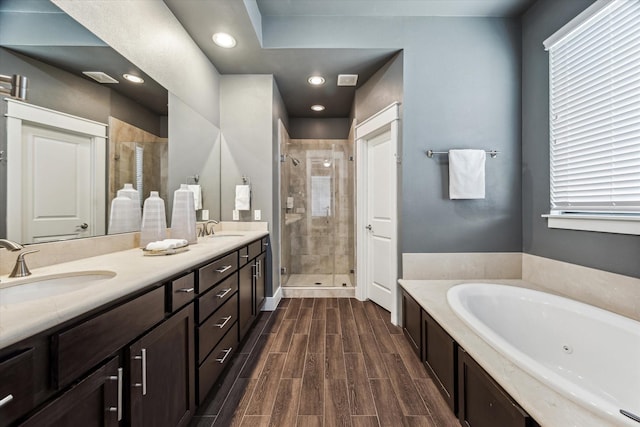 783 Waverly St, Houston, TX 77007 - full bath featuring a stall shower, a tub with jets, plenty of natural light, wood finished floors, and recessed lighting