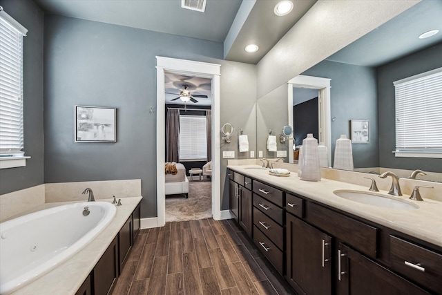 783 Waverly St, Houston, TX 77007 - bathroom featuring a bath, double vanity, baseboards, wood finished floors, and a ceiling fan