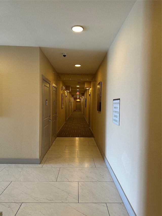6955 Turtlewood Dr Unit 502, Houston, TX 77072 - hallway with baseboards, light marble finish flooring, and recessed lighting