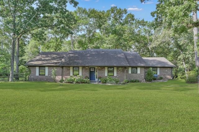 914 Rustic Oaks Dr, Magnolia, TX 77354 - ranch-style home with a front lawn, brick siding, and a shingled roof