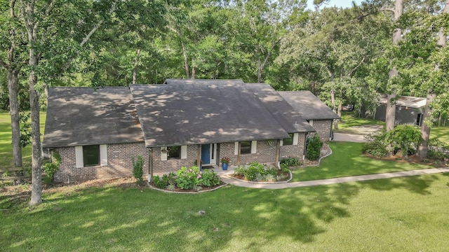 914 Rustic Oaks Dr, Magnolia, TX 77354 - view of front of house with brick siding, a front lawn, and a shingled roof