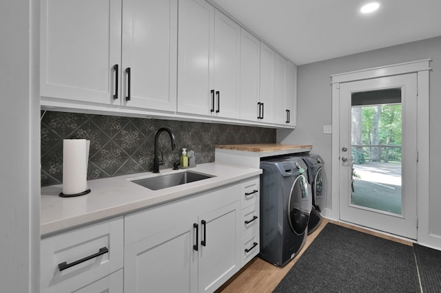 914 Rustic Oaks Dr, Magnolia, TX 77354 - laundry area featuring washer and clothes dryer, cabinet space, light wood-style flooring, and recessed lighting