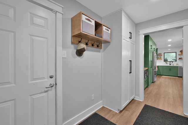 914 Rustic Oaks Dr, Magnolia, TX 77354 - mudroom featuring light wood-style flooring, a sink, baseboards, and recessed lighting