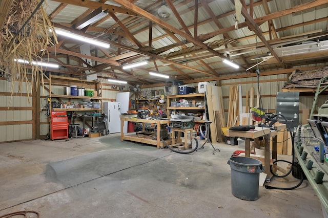 914 Rustic Oaks Dr, Magnolia, TX 77354 - garage featuring a workshop area and freestanding refrigerator