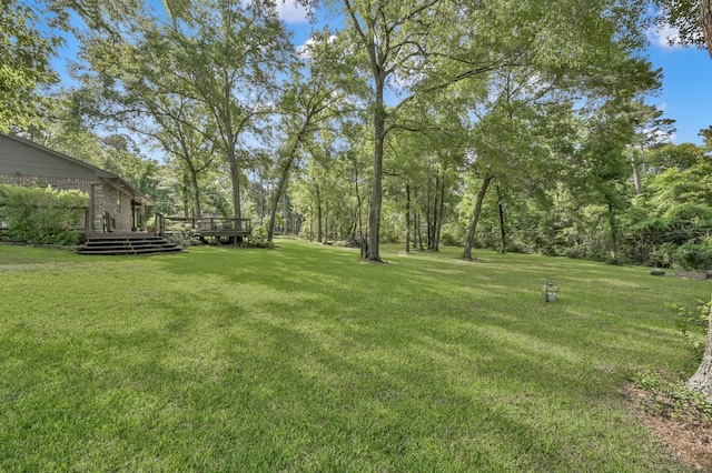 914 Rustic Oaks Dr, Magnolia, TX 77354 - view of grassy yard with a wooden deck