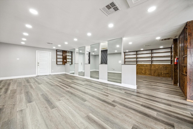2106 Antoine Dr, Houston, TX 77055 - basement featuring light wood-style floors, baseboards, and recessed lighting