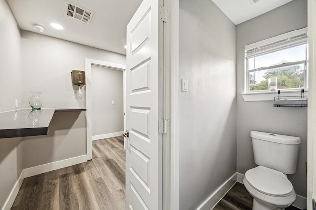 2106 Antoine Dr, Houston, TX 77055 - bathroom featuring wood finished floors, baseboards, and toilet