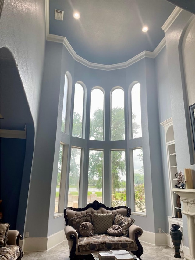 8930 Water Crest Trl, Richmond, TX 77469 - living area featuring a towering ceiling, crown molding, and baseboards