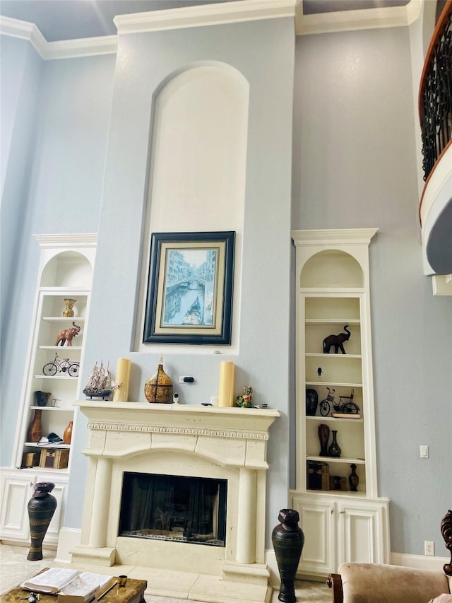 8930 Water Crest Trl, Richmond, TX 77469 - living area with built in shelves, ornamental molding, and a fireplace