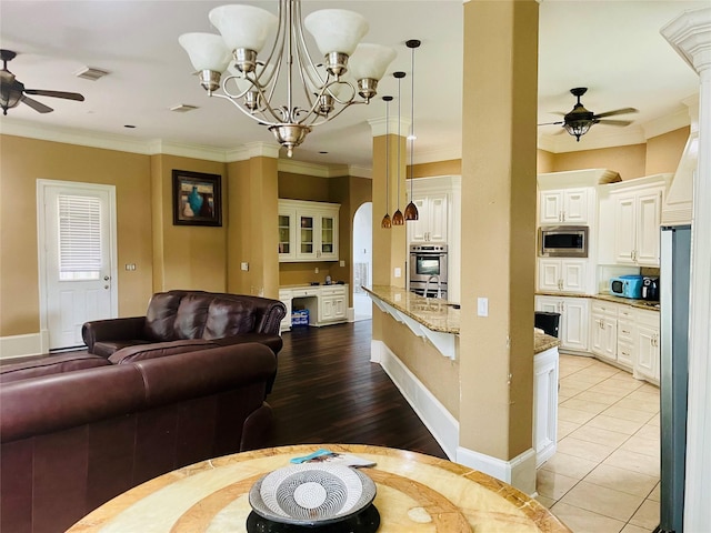 8930 Water Crest Trl, Richmond, TX 77469 - dining area featuring ceiling fan, crown molding, a chandelier, light wood finished floors, and baseboards