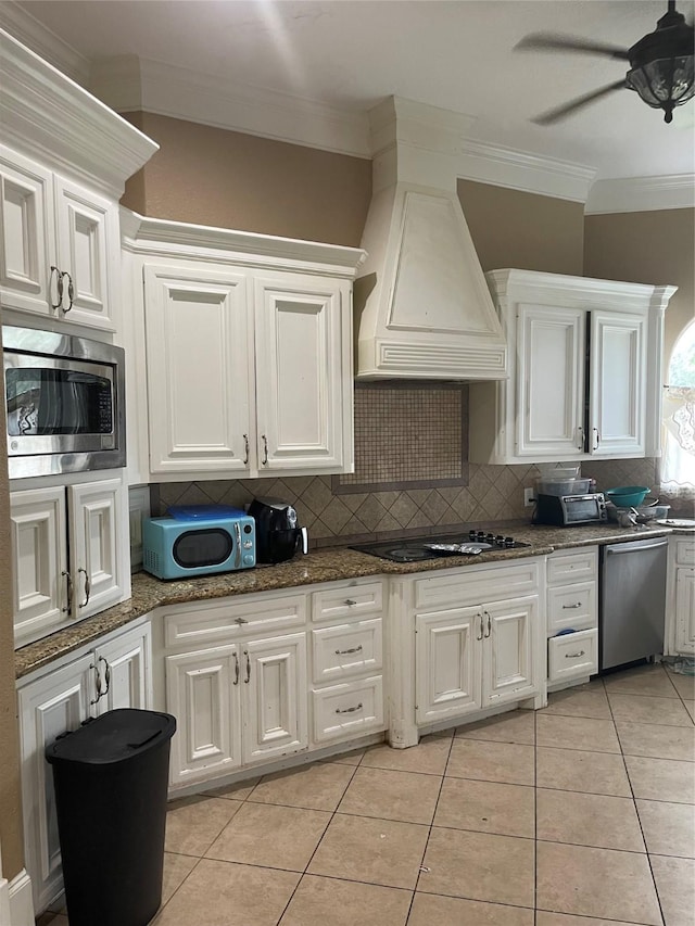 8930 Water Crest Trl, Richmond, TX 77469 - kitchen featuring stainless steel appliances, custom exhaust hood, tasteful backsplash, crown molding, and white cabinetry