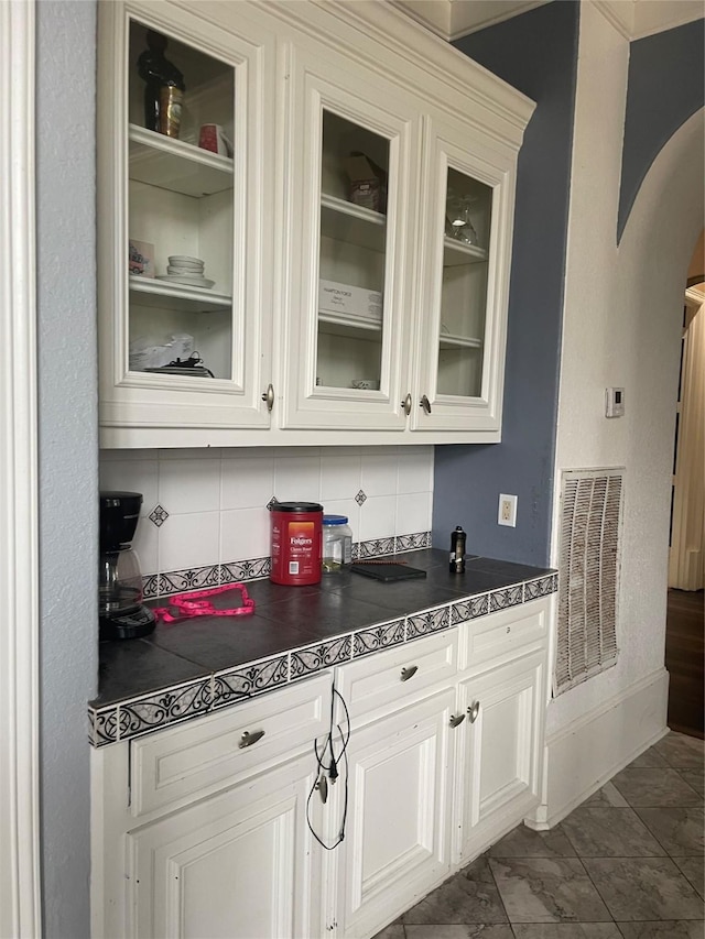 8930 Water Crest Trl, Richmond, TX 77469 - bar with backsplash, arched walkways, and dark marble finish floors