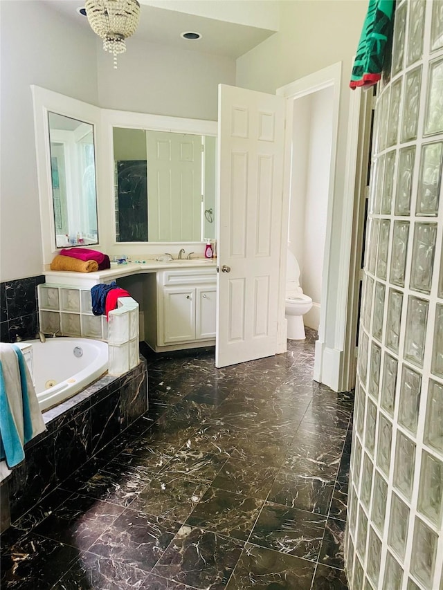 8930 Water Crest Trl, Richmond, TX 77469 - bathroom featuring a jetted tub, marble finish flooring, vanity, and toilet
