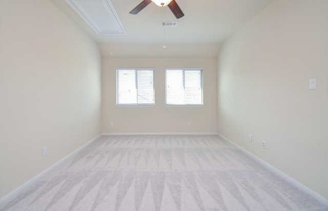 unfurnished room with attic access, light carpet, ceiling fan, and baseboards