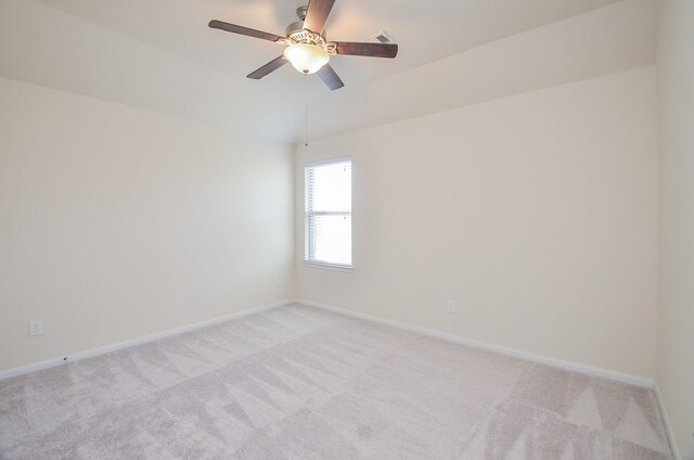 unfurnished room with light colored carpet, ceiling fan, and baseboards