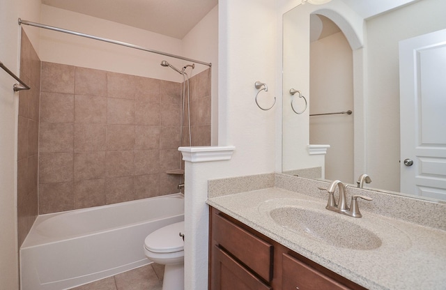 full bathroom featuring toilet, tile patterned flooring, vanity, and  shower combination