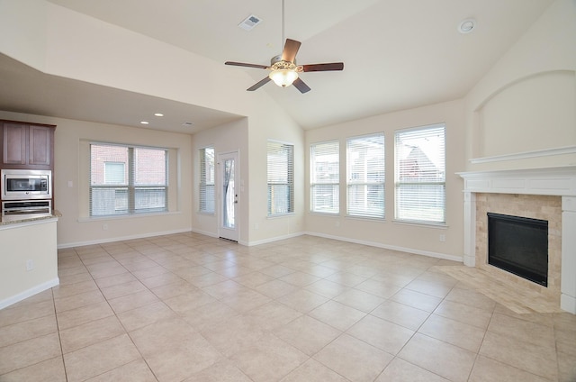 unfurnished living room featuring light tile patterned floors, a ceiling fan, a tile fireplace, baseboards, and recessed lighting