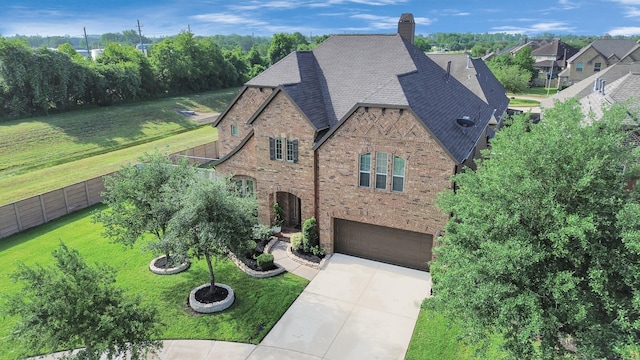 view of front facade featuring brick siding, a garage, driveway, a chimney, and a shingled roof