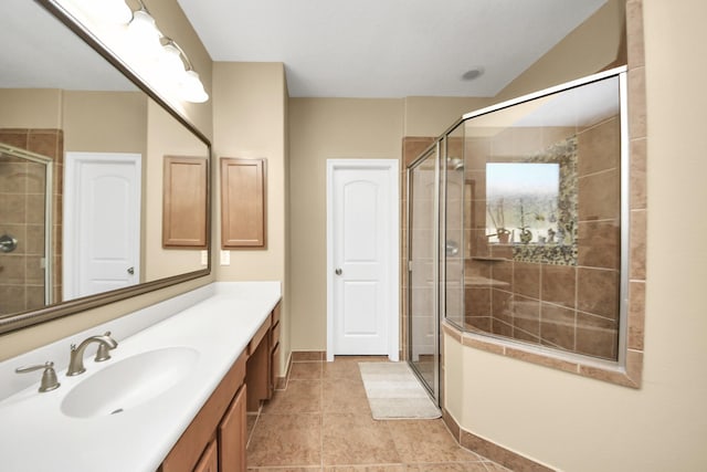 full bathroom with a stall shower, vanity, tile patterned floors, and baseboards