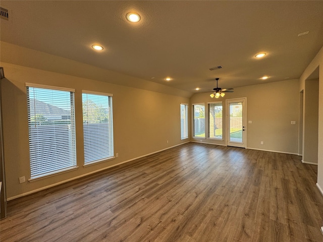 unfurnished living room featuring a ceiling fan, wood finished floors, plenty of natural light, baseboards, and recessed lighting