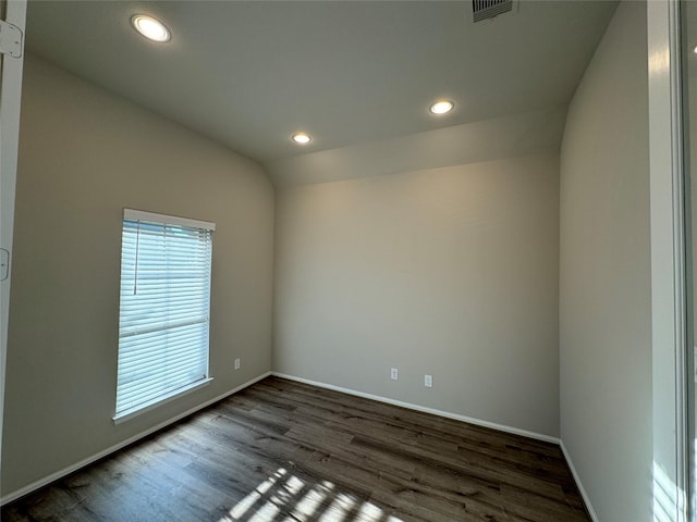 unfurnished room with dark wood finished floors, baseboards, recessed lighting, and vaulted ceiling