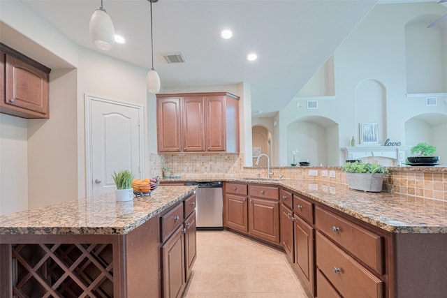 kitchen with dishwasher, a sink, light stone counters, backsplash, and decorative light fixtures