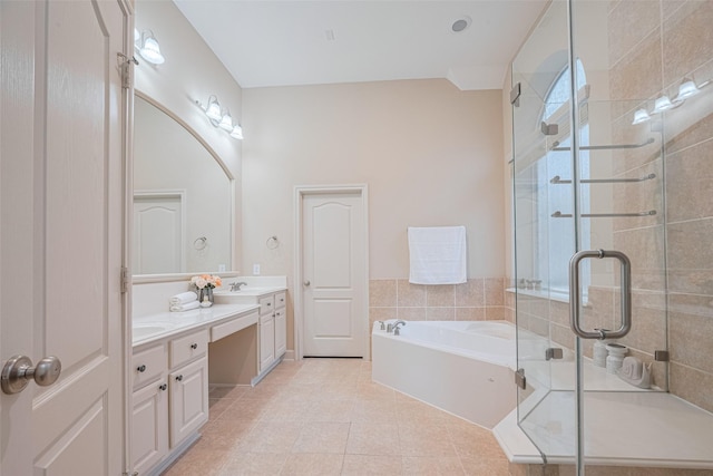 full bath with double vanity, a stall shower, tile patterned flooring, and a bath
