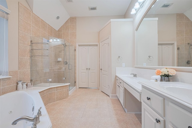 bathroom featuring a shower stall, a jetted tub, tile patterned flooring, double vanity, and lofted ceiling