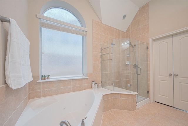 full bath featuring vaulted ceiling, a shower stall, a tub with jets, and tile patterned floors