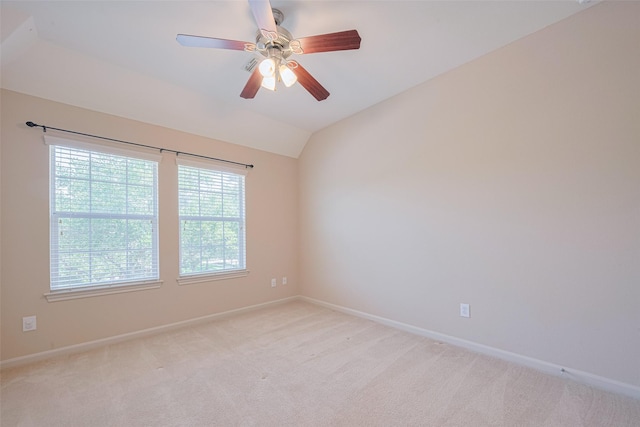 unfurnished room with baseboards, light colored carpet, and vaulted ceiling