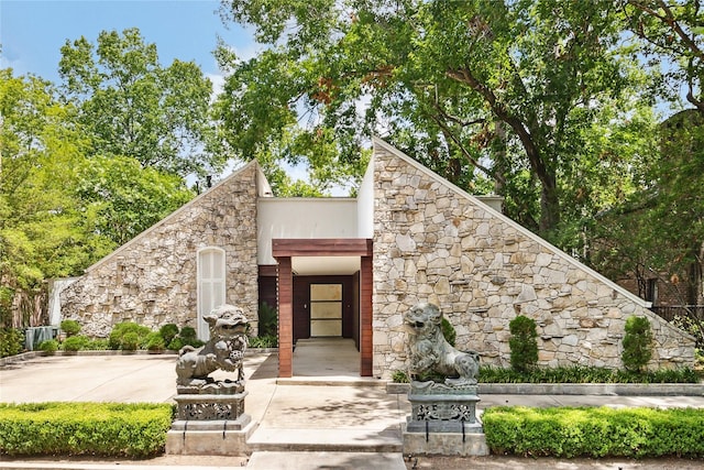 doorway to property with stone siding