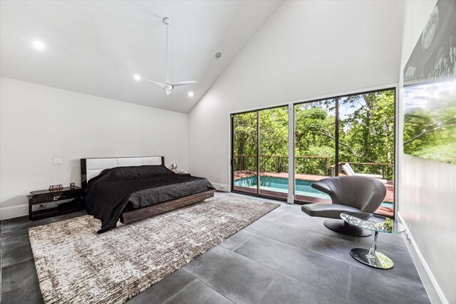 bedroom with access to outside, high vaulted ceiling, baseboards, recessed lighting, and concrete flooring