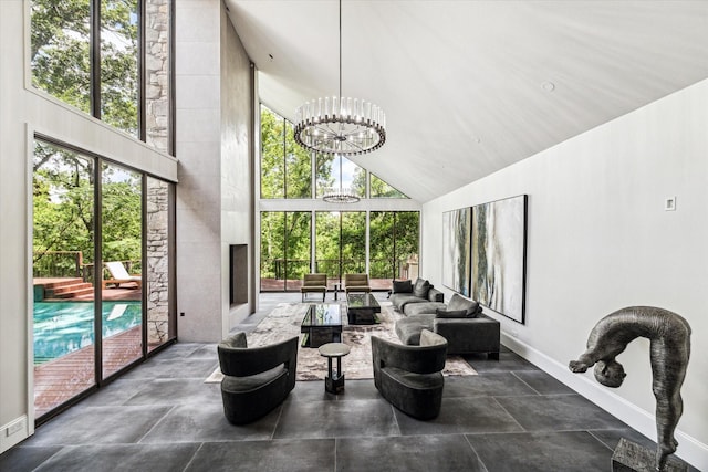 sunroom / solarium with a chandelier, healthy amount of natural light, and lofted ceiling