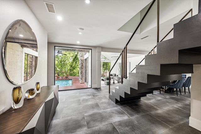 stairway with recessed lighting and baseboards