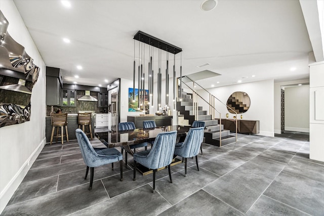 dining space with stairway, baseboards, recessed lighting, and a community bar