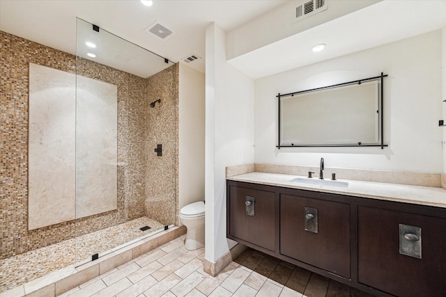 bathroom featuring toilet, a stall shower, vanity, recessed lighting, and tile patterned floors