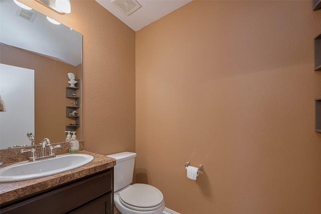 half bath featuring toilet and vanity