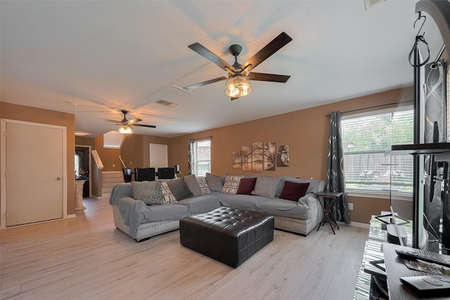 living room featuring a ceiling fan, light wood-style flooring, and baseboards